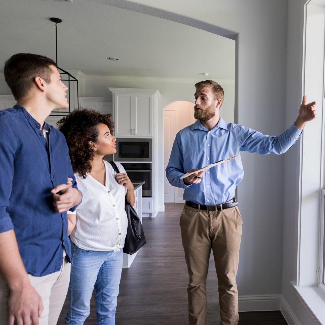 An agent walking a couple through a home